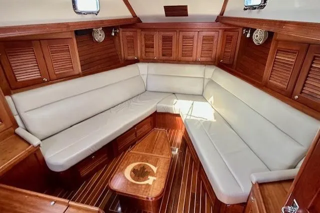 Blue Moon Yacht Photos Pics Luxurious interior of 2016 Gozzard 41 RC yacht with elegant wood finish and plush seating.