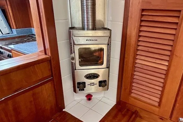 Blue Moon Yacht Photos Pics Stainless steel stove in 2016 Gozzard 41 RC yacht interior, featuring wooden cabinetry.