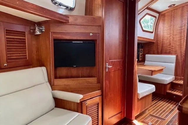 Blue Moon Yacht Photos Pics Luxurious interior of 2016 Gozzard 41 RC yacht with wood finish and seating area.