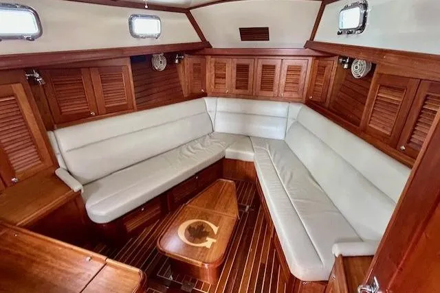 Blue Moon Yacht Photos Pics Luxurious interior of 2016 Gozzard 41 RC yacht with elegant wood finish and plush seating.