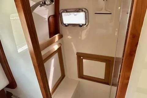 Blue Moon Yacht Photos Pics 2016 Gozzard 41 RC yacht bathroom with wooden accents and porthole window.