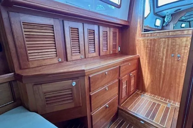 Blue Moon Yacht Photos Pics Luxurious wooden interior of 2016 Gozzard 41 RC yacht, featuring cabinets and drawers.