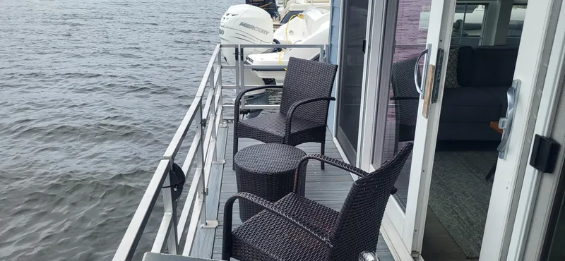  Yacht Photos Pics 2020 Destination Yachts 16x45 Condo Series houseboat with deck chairs overlooking the water.