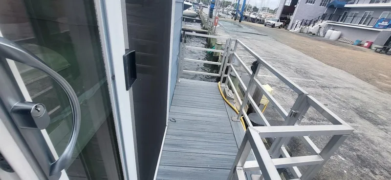  Yacht Photos Pics 2020 Destination Yachts 16x45 Condo Series docked at marina, side view.