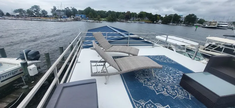  Yacht Photos Pics Rooftop deck of 2020 Destination Yachts 16x45 Condo Series with lounge chairs and scenic water view.