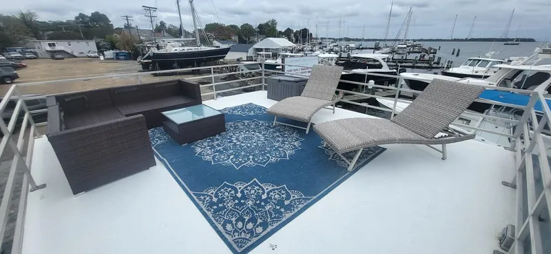  Yacht Photos Pics 2020 Destination Yachts 16x45 Condo Series rooftop deck with lounge chairs and blue rug.