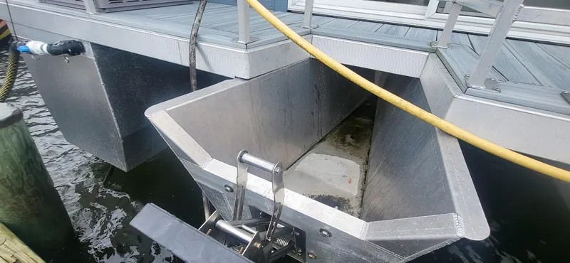  Yacht Photos Pics 2020 Destination Yachts 16x45 Condo Series houseboat hull detail at dock.