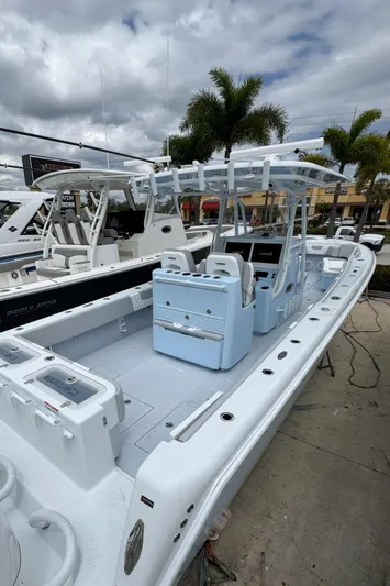 35-261 Yacht Photos Pics 2025 Contender 35 ST boat with sleek design, docked under cloudy skies.