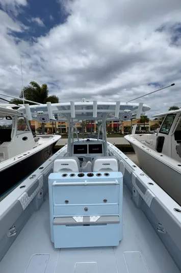 35-261 Yacht Photos Pics 2025 Contender 35 ST boat with sleek design, docked under cloudy sky.