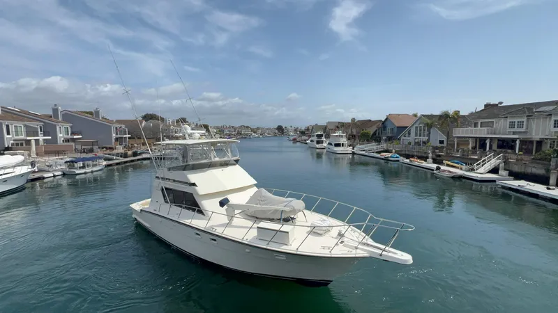 White Shark Yacht Photos Pics 1988 Hatteras 48 Convertible yacht cruising in a scenic residential canal.