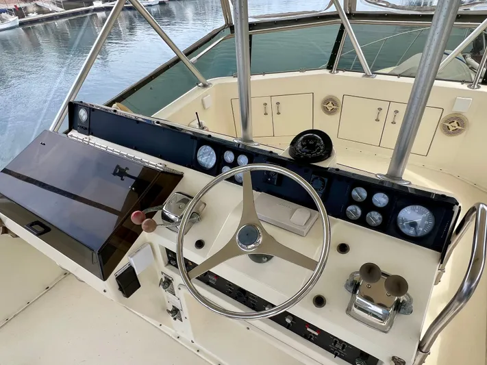 White Shark Yacht Photos Pics Helm of 1988 Hatteras 48 Convertible yacht with steering wheel and gauges.