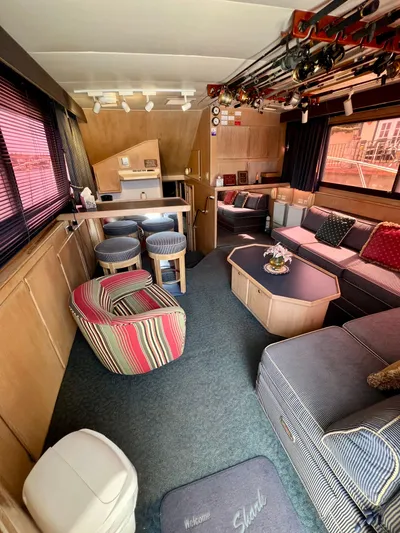 White Shark Yacht Photos Pics Interior of 1988 Hatteras 48 Convertible yacht with cozy seating and fishing rods.