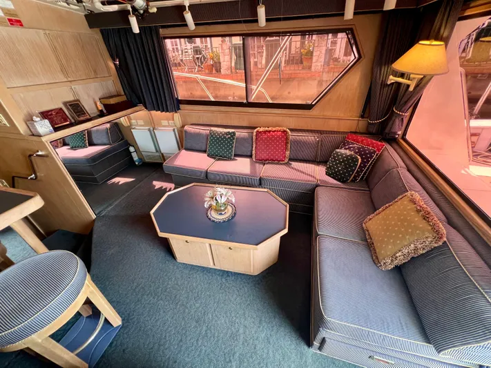 White Shark Yacht Photos Pics Luxurious interior of 1988 Hatteras 48 Convertible yacht with plush seating and elegant decor.