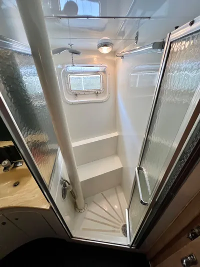 White Shark Yacht Photos Pics Compact shower in 1988 Hatteras 48 Convertible yacht with frosted glass door and porthole window.