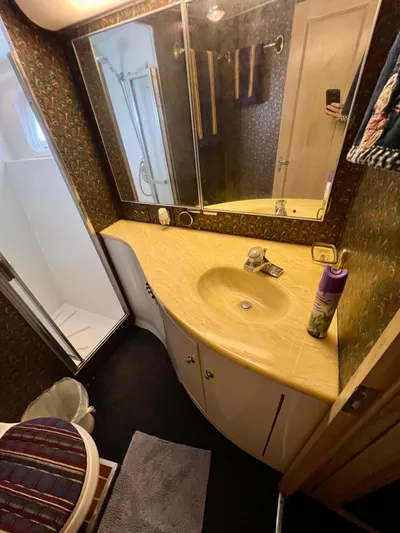 White Shark Yacht Photos Pics Bathroom interior of 1988 Hatteras 48 Convertible yacht with yellow countertop and shower.