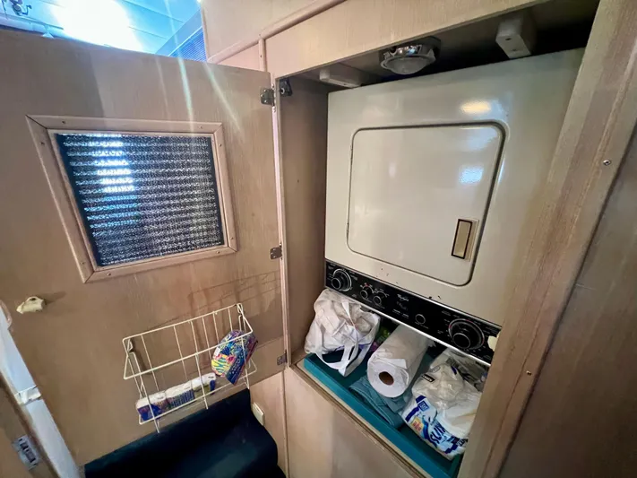 White Shark Yacht Photos Pics Laundry area inside 1988 Hatteras 48 Convertible yacht with storage and supplies.