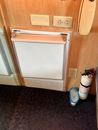 White Shark Yacht Photos Pics Interior of 1988 Hatteras 48 Convertible with panel, outlets, and fire extinguisher.