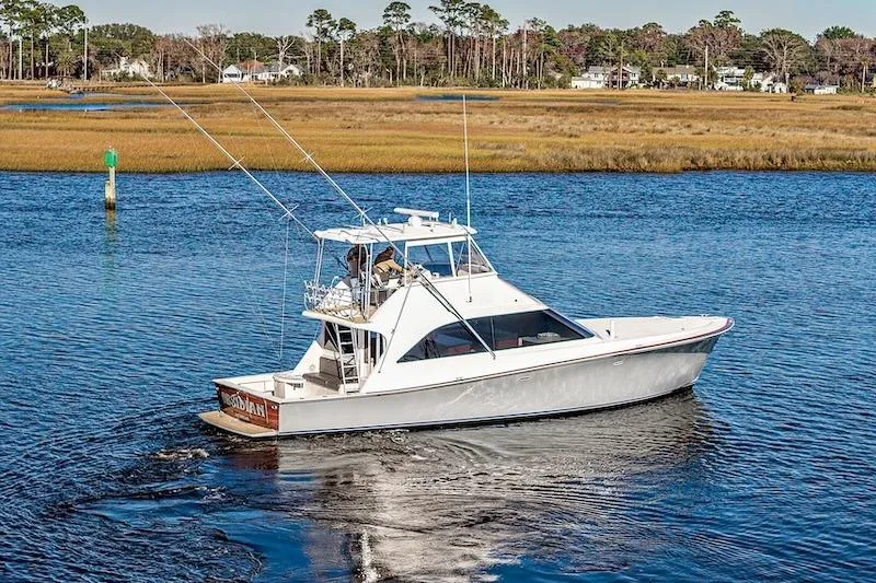 Obsidian Yacht Photos Pics 1991 Ocean Yachts 53 Super Sport cruising on a serene waterway.