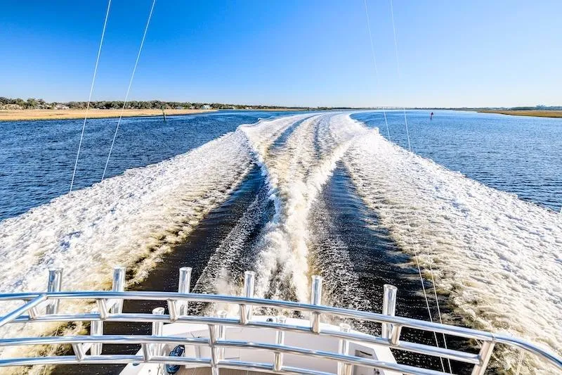 Obsidian Yacht Photos Pics Ocean Yachts 1991 53 Super Sport cruising, leaving a wake on a sunny day.