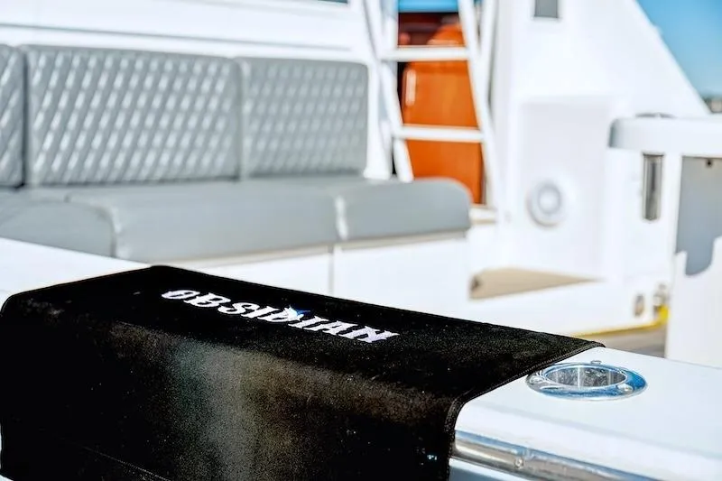 Obsidian Yacht Photos Pics 1991 Ocean Yachts 53 Super Sport interior with seating and branded towel.