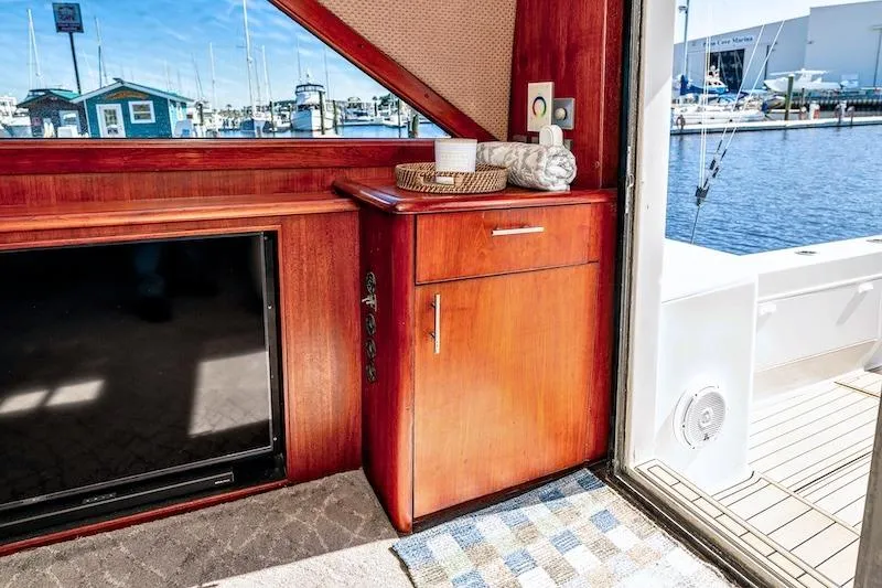 Obsidian Yacht Photos Pics Interior of 1991 Ocean Yachts 53 Super Sport with wooden cabinetry and marina view.