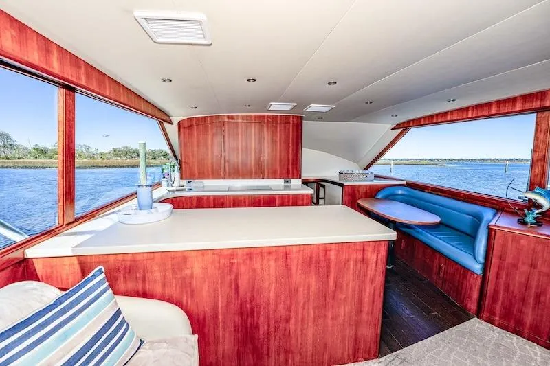 Obsidian Yacht Photos Pics Interior of 1991 Ocean Yachts 53 Super Sport with wood finish and blue seating.