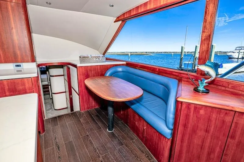 Obsidian Yacht Photos Pics Interior of 1991 Ocean Yachts 53 Super Sport with wood finish and blue seating.