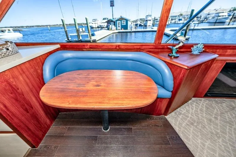 Obsidian Yacht Photos Pics Interior of 1991 Ocean Yachts 53 Super Sport with blue seating and wooden table.
