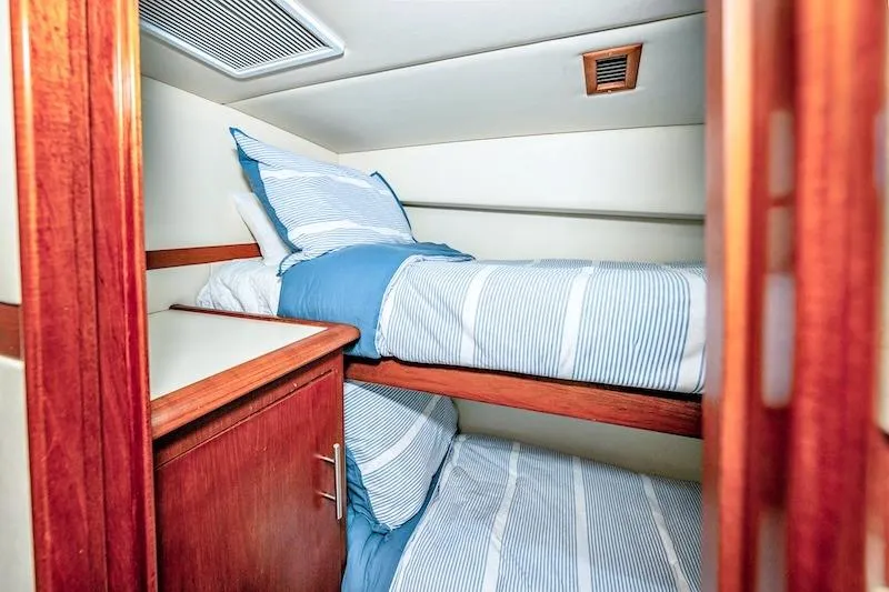 Obsidian Yacht Photos Pics Interior cabin of 1991 Ocean Yachts 53 Super Sport with bunk beds and wooden cabinetry.