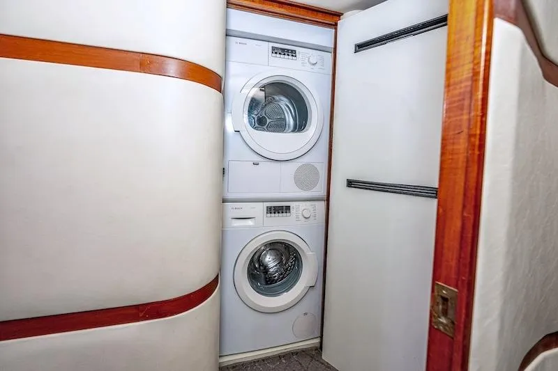 Obsidian Yacht Photos Pics Laundry area inside 1991 Ocean Yachts 53 Super Sport, featuring stacked washer and dryer.