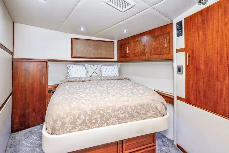 Obsidian Yacht Photos Pics Luxurious bedroom interior of 1991 Ocean Yachts 53 Super Sport with elegant wood cabinetry.