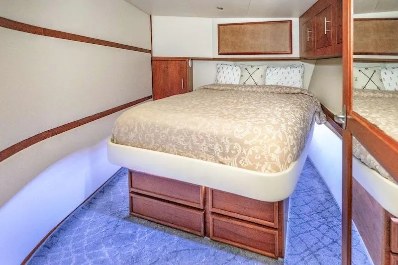 Obsidian Yacht Photos Pics Luxurious bedroom interior of 1991 Ocean Yachts 53 Super Sport with elegant bedding and wood accents.