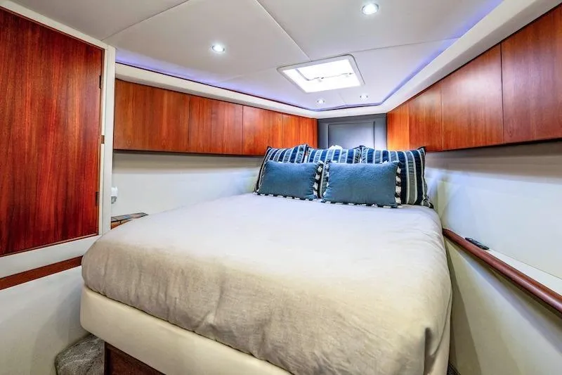 Obsidian Yacht Photos Pics Luxurious cabin interior of 1991 Ocean Yachts 53 Super Sport with cozy bedding.