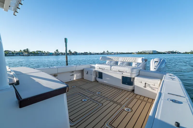 Liberado Yacht Photos Pics 2018 HCB 53 Suenos RXV boat deck with seating, overlooking calm waters.
