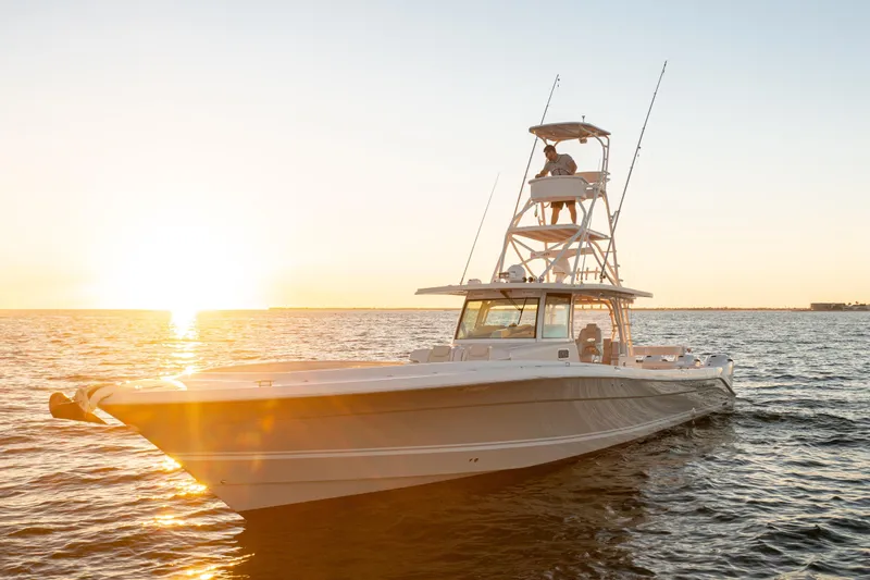 Liberado Yacht Photos Pics 2018 HCB 53 Suenos RXV boat on water at sunset.