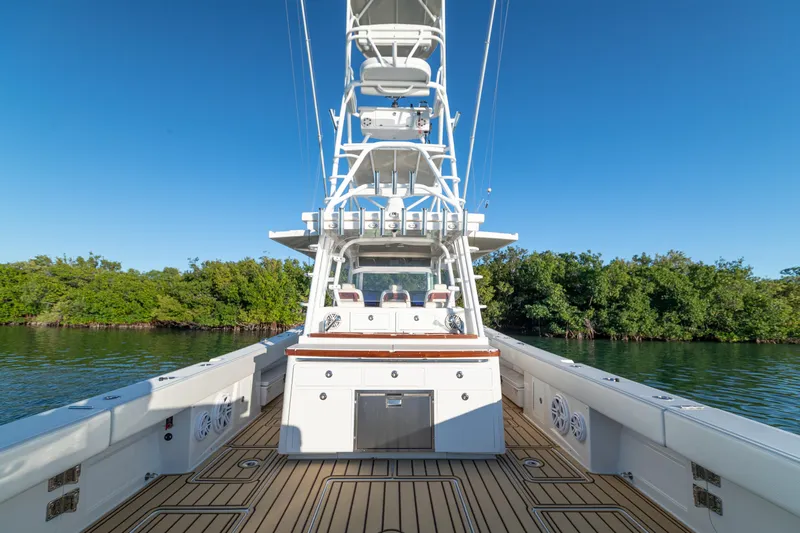 Liberado Yacht Photos Pics 2018 HCB 53 Suenos RXV boat with spacious deck and tower, surrounded by lush greenery.