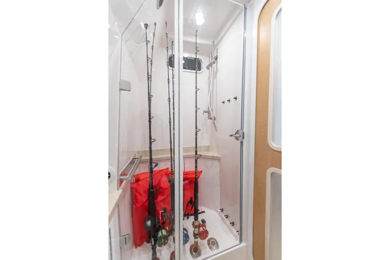 Liberado Yacht Photos Pics Interior of 2018 HCB 53 Suenos RXV boat with fishing rod storage.