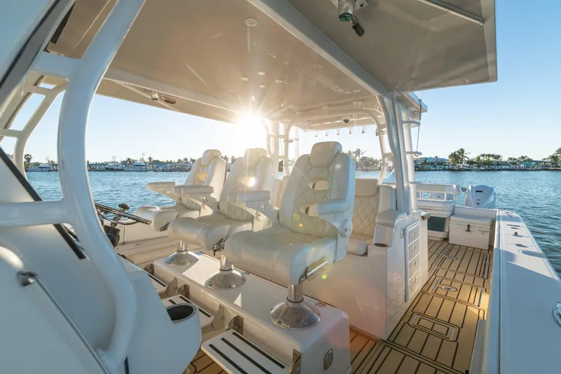 Liberado Yacht Photos Pics Luxurious 2018 HCB 53 Suenos RXV boat interior with plush seating and scenic water view.