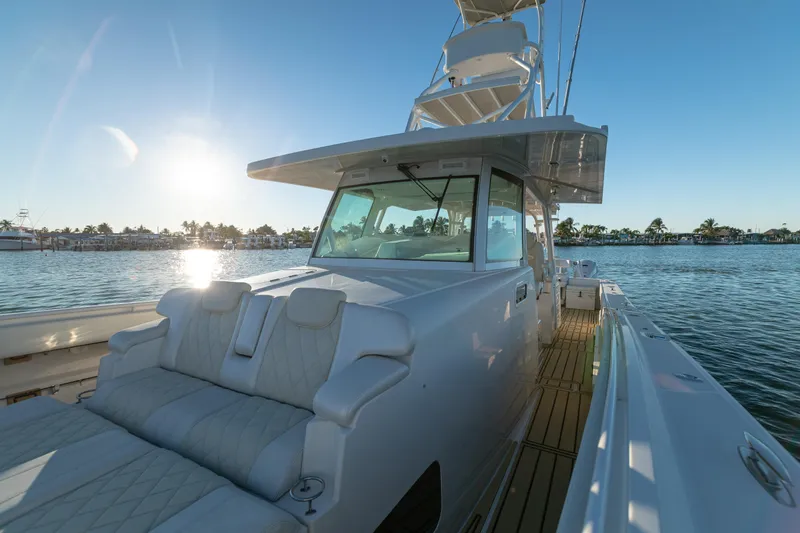 Liberado Yacht Photos Pics 2018 HCB 53 Suenos RXV yacht on water at sunset, showcasing luxury seating.