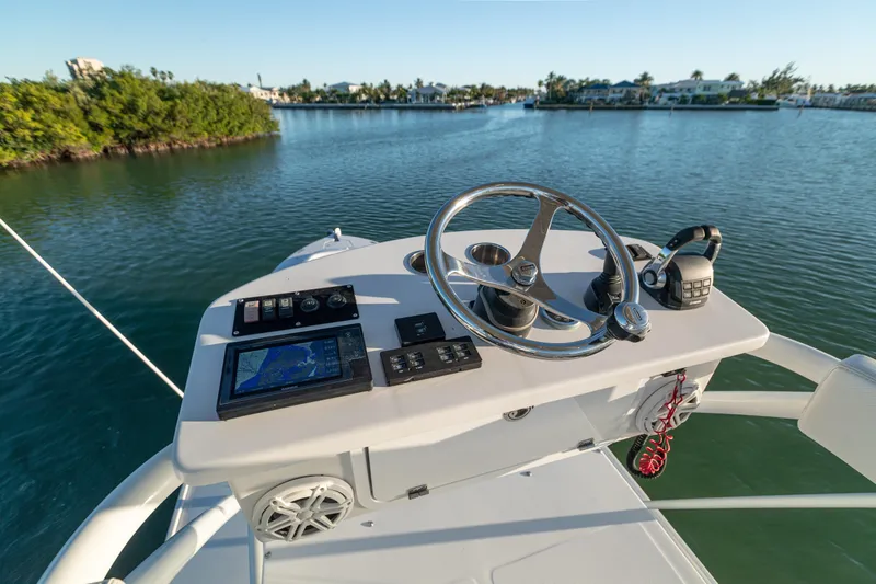 Liberado Yacht Photos Pics 2018 HCB 53 Suenos RXV boat helm with navigation controls on calm water.