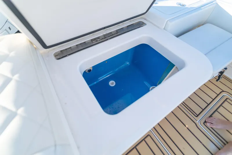 Liberado Yacht Photos Pics Open storage compartment on 2018 HCB 53 Suenos RXV boat, featuring blue interior.