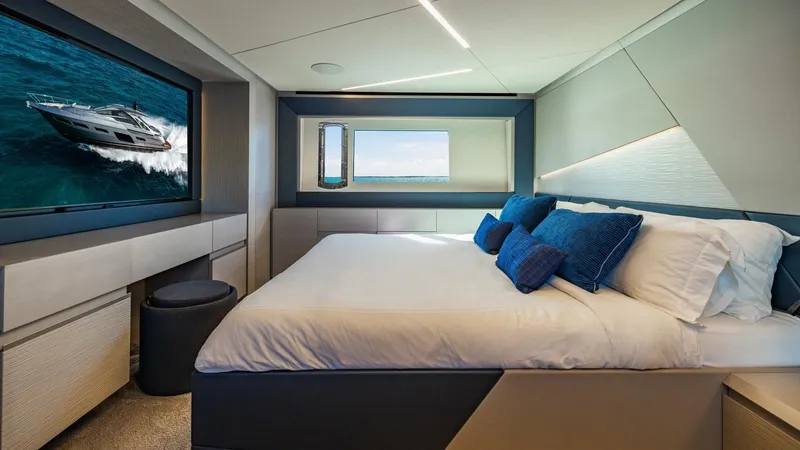 Unreel Yacht Photos Pics Luxurious bedroom interior of 2023 Pershing 7X yacht with modern design and ocean view.