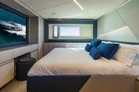 Luxurious bedroom interior of 2023 Pershing 7X yacht with modern design and ocean view.