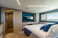 Luxurious bedroom interior of 2023 Pershing 7X yacht with modern design and ocean view.