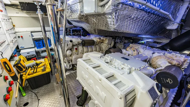 Unreel Yacht Photos Pics Engine room of 2023 Pershing 7X yacht, featuring advanced machinery and equipment.