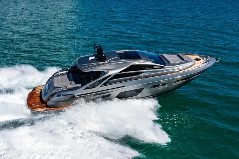 Unreel Yacht Photos Pics 2023 Pershing 7X yacht cruising swiftly on open blue waters.