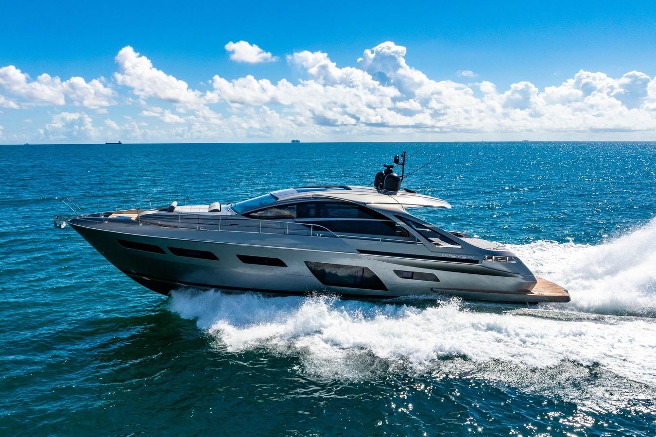 2023 Pershing 7X yacht cruising on open sea under clear blue sky.