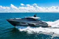 2023 Pershing 7X yacht cruising on open sea under clear blue sky.