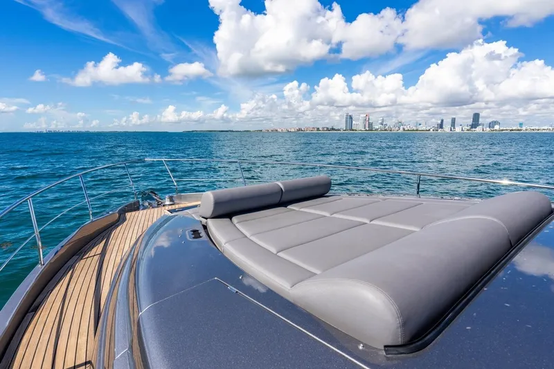 Unreel Yacht Photos Pics 2023 Pershing 7X yacht deck with city skyline and ocean view.