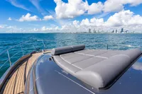 2023 Pershing 7X yacht deck with city skyline and ocean view.